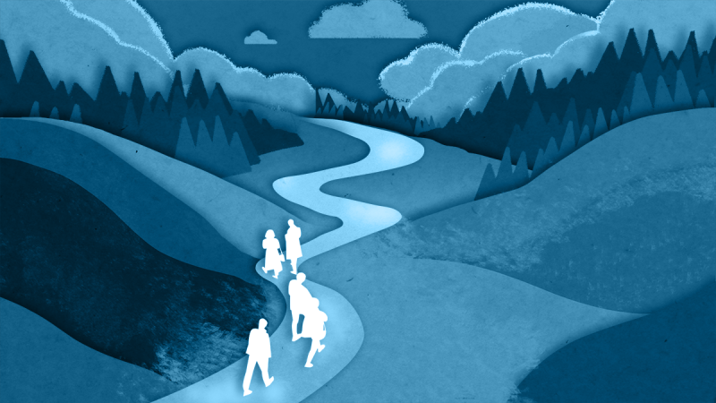 People walking along a path that slopes gradually uphill