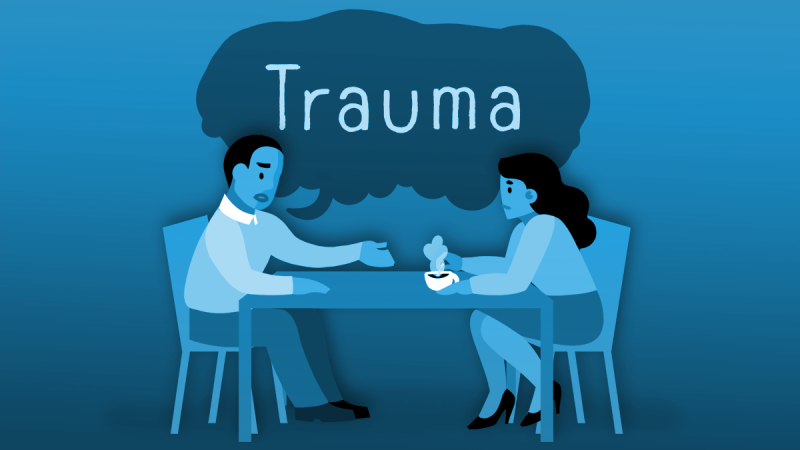 A pair of people having an interview with the word "trauma" in a speech bubble